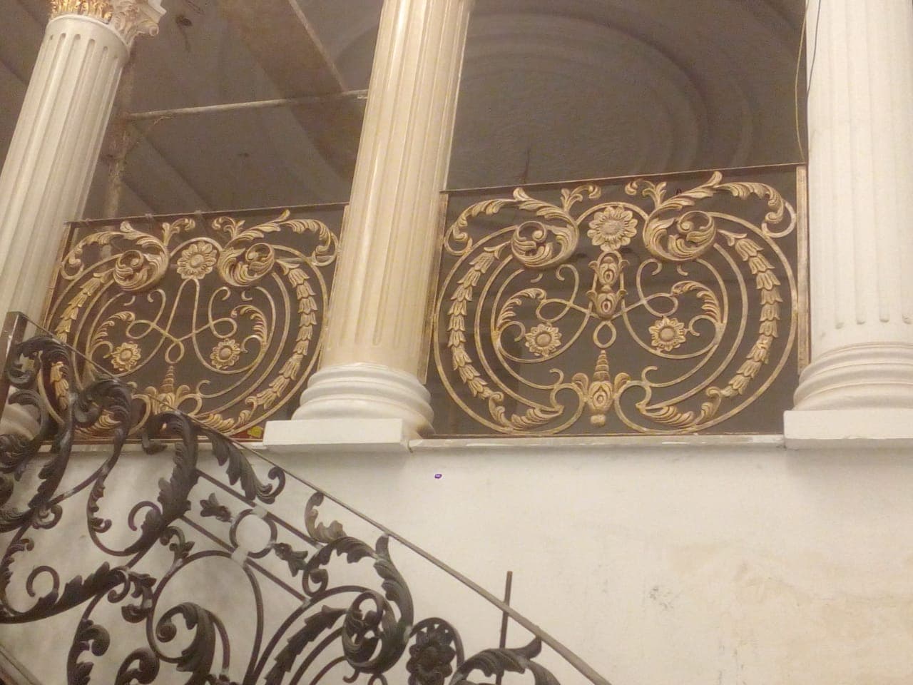 Intricate Golden Wrought Iron Balcony